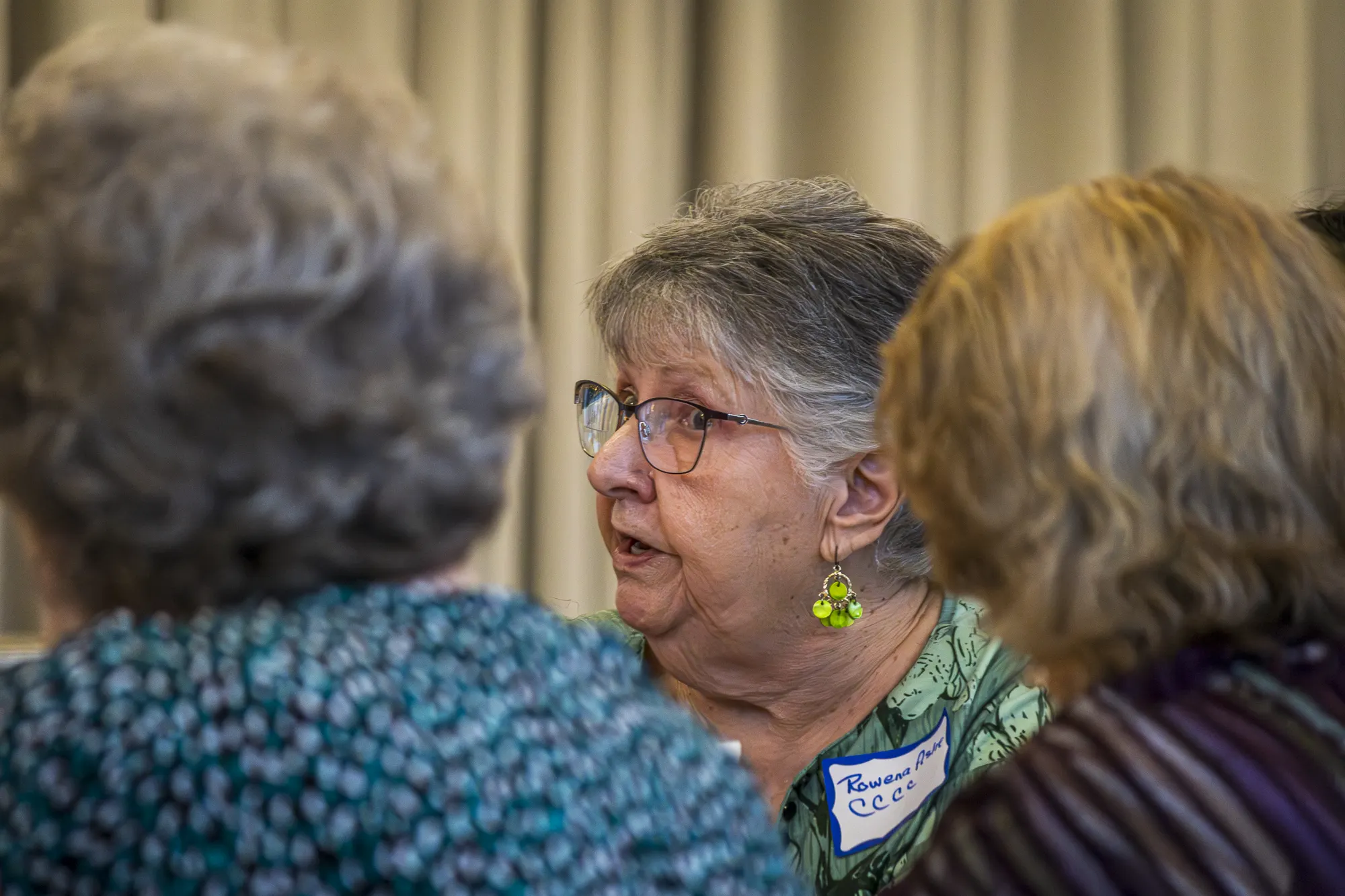 A Community Connectors attendee speaking with neighbors in a listening circle.