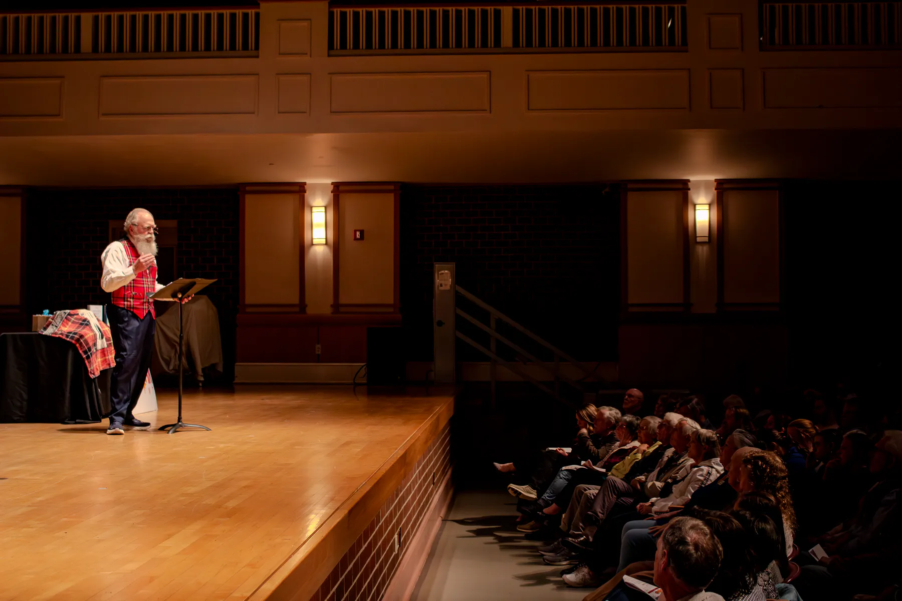 Dr. Ora Wells speaking at the podium as the audience listens