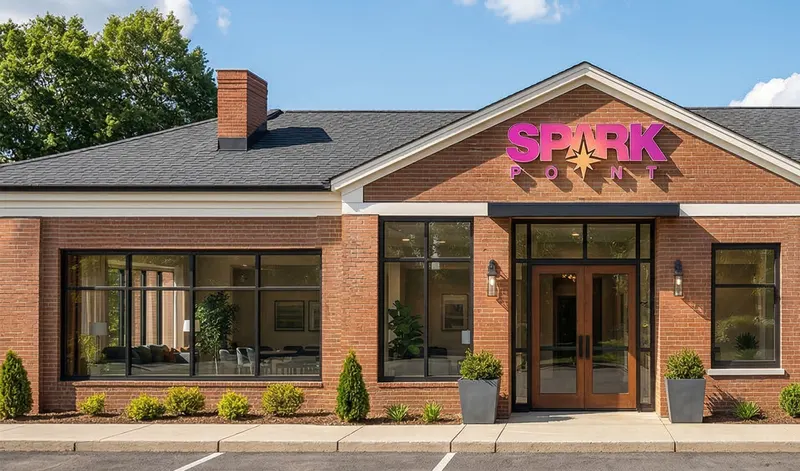 The brick front of the SparkPoint Resilience Hub, its sign over the entrance.