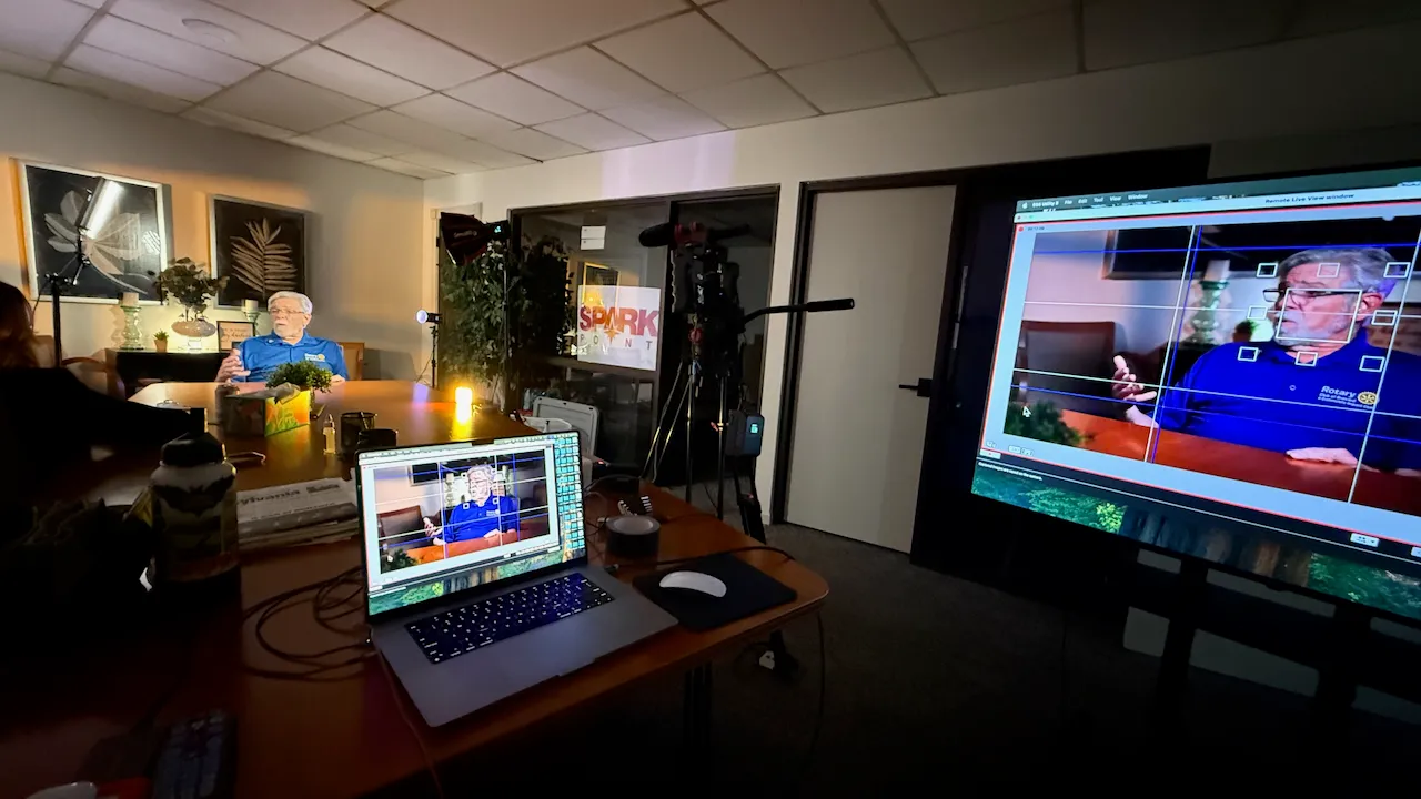 A remote-monitored interview being filmed for the Helene: One Year of Healing tribute film at the SparkPoint office.
